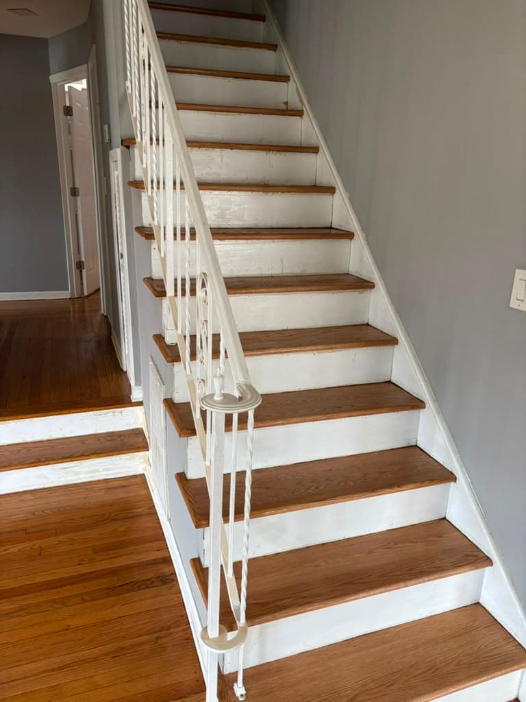 Same staircase fully refinished with oak treads and white risers