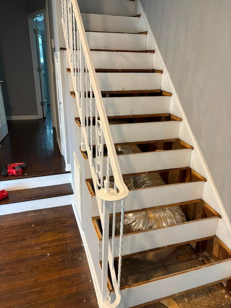 Staircase treads removed down to subfloor before refinishing