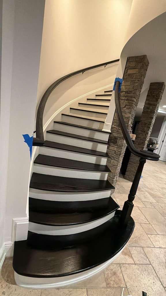 Curved staircase refinished in modern black finish