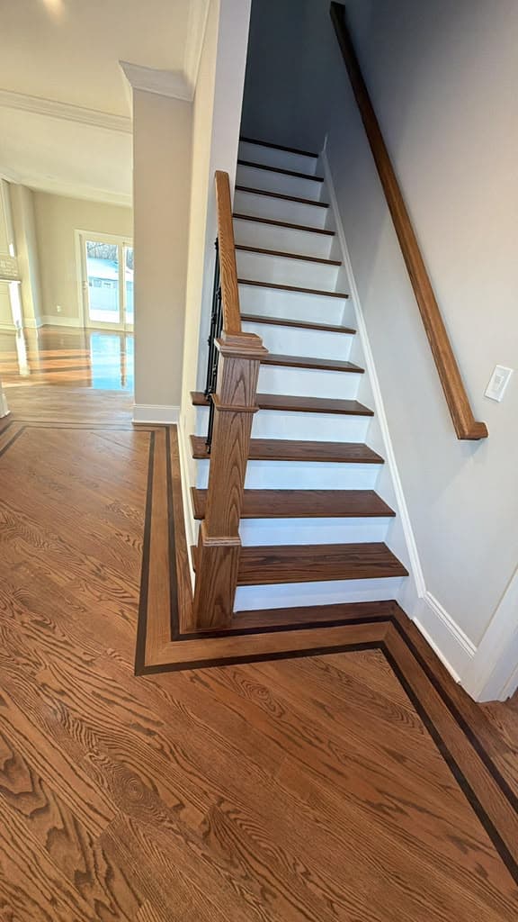 Finished staircase with matching hardwood border inlay